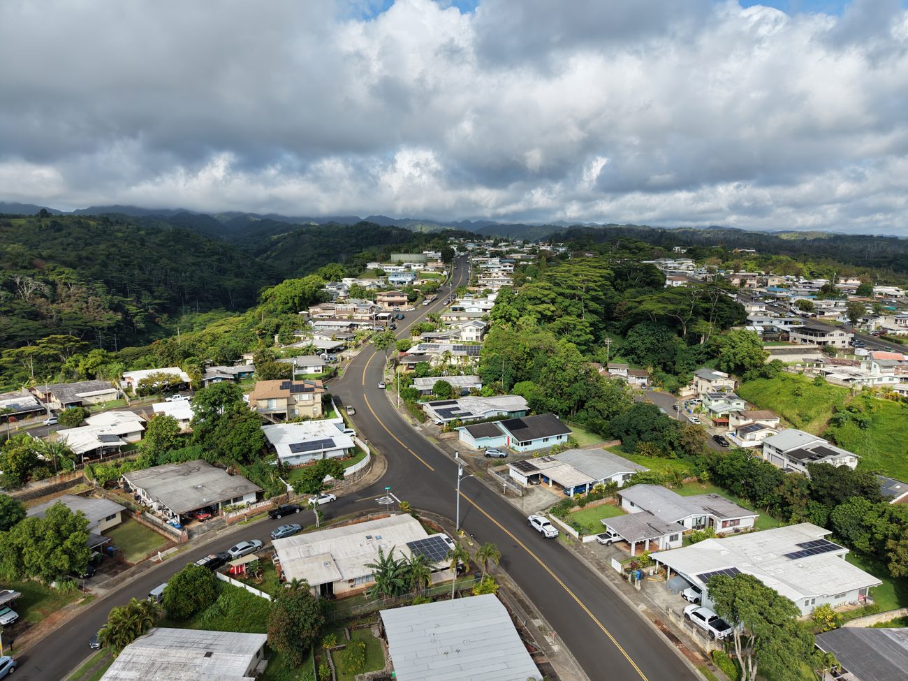 Aerial photo of an Oʻahu neighborhood showing streets, homes and hills in context